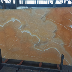 Beautiful Deep Orange onyx slab with striking white veins and geode-like patterns, perfect for luxury interiors